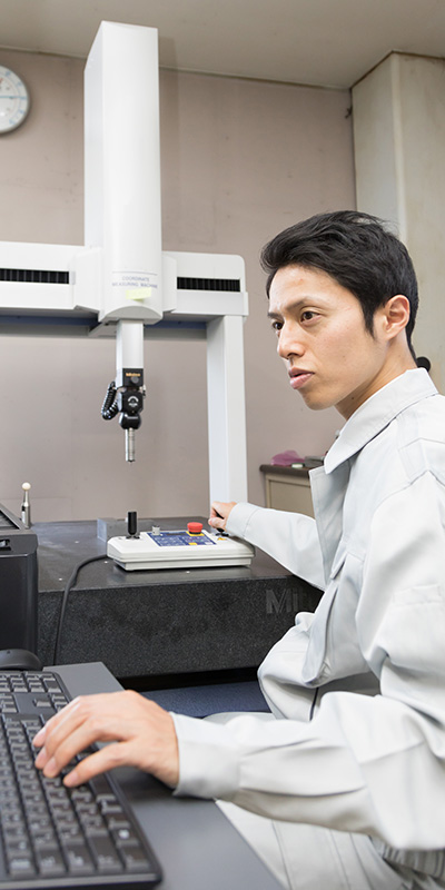 a male engineer checking products with PC