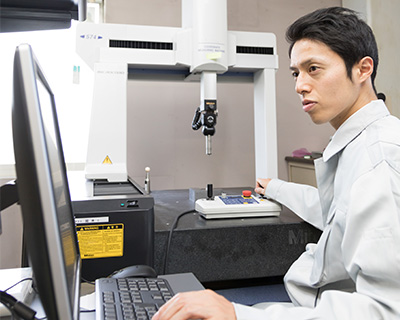 a male engineer checking products with PC