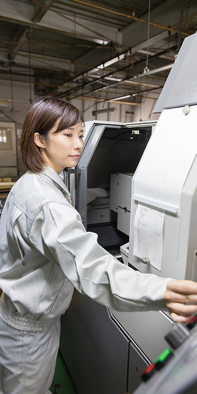 a famale engineer operating a large machine