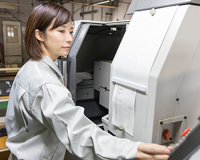 a famale engineer operating a large machine